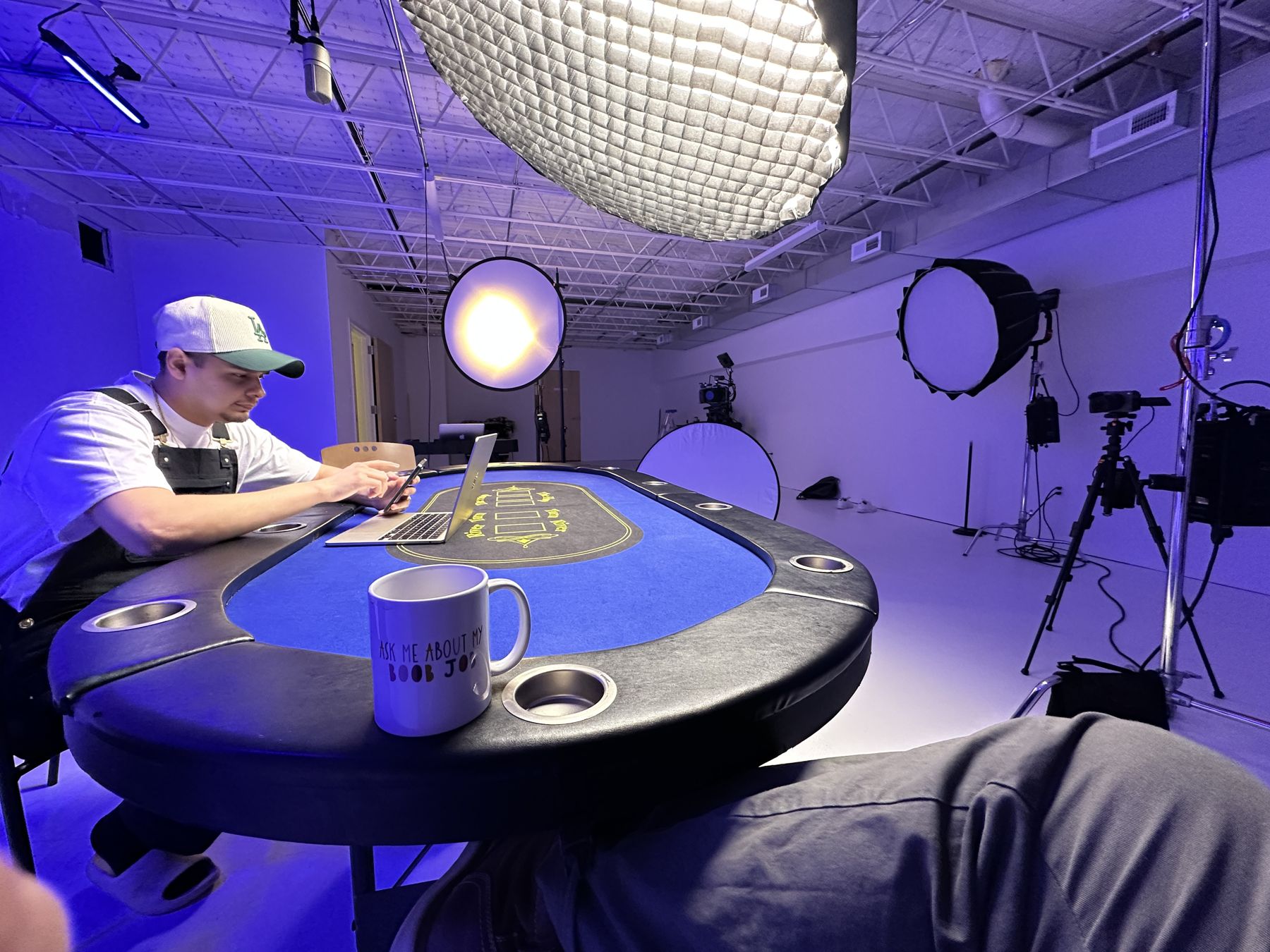 Three-person podcast under purple light